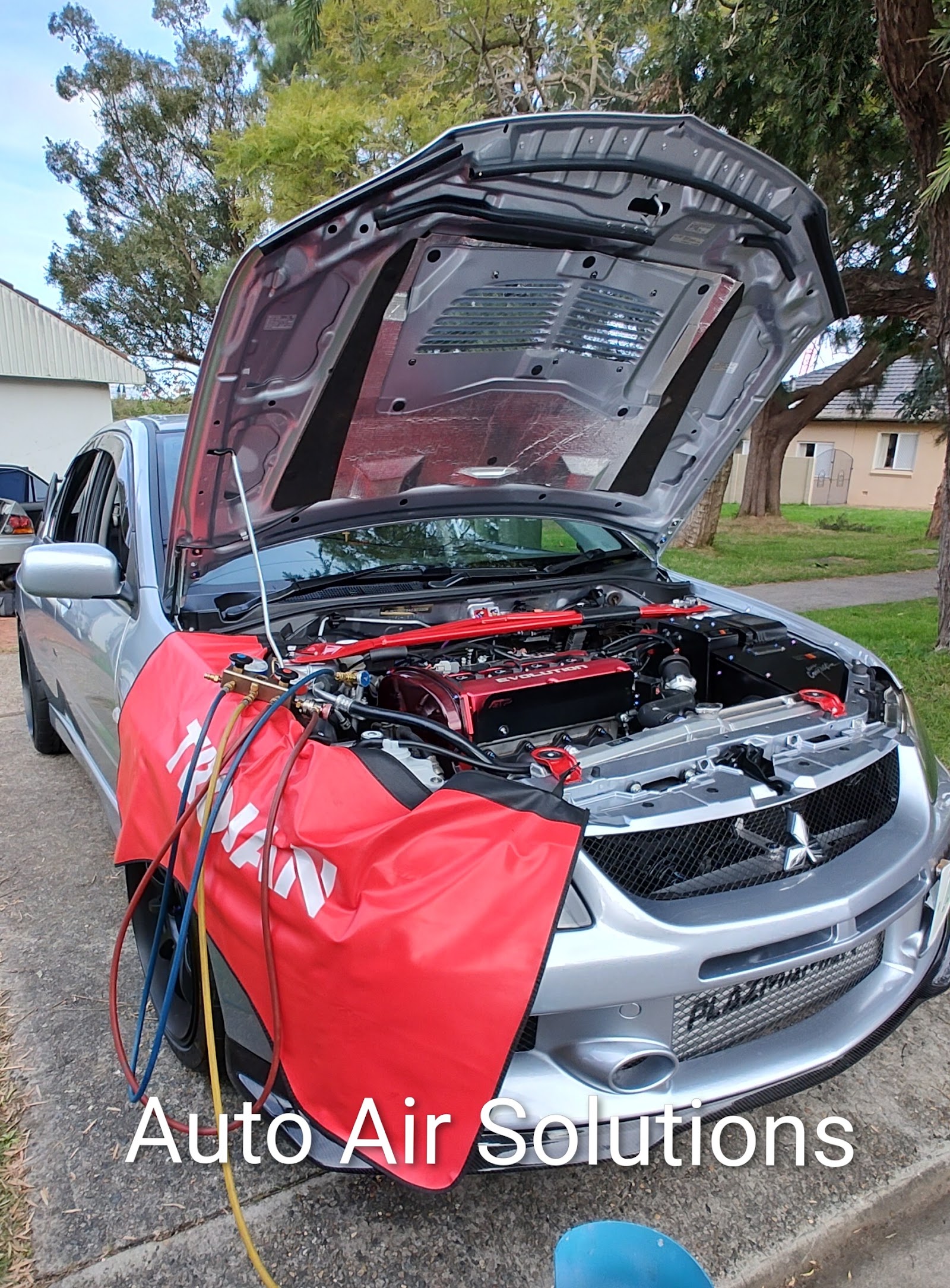 A/C regas in progress on a modified Mitsubishi Evolution